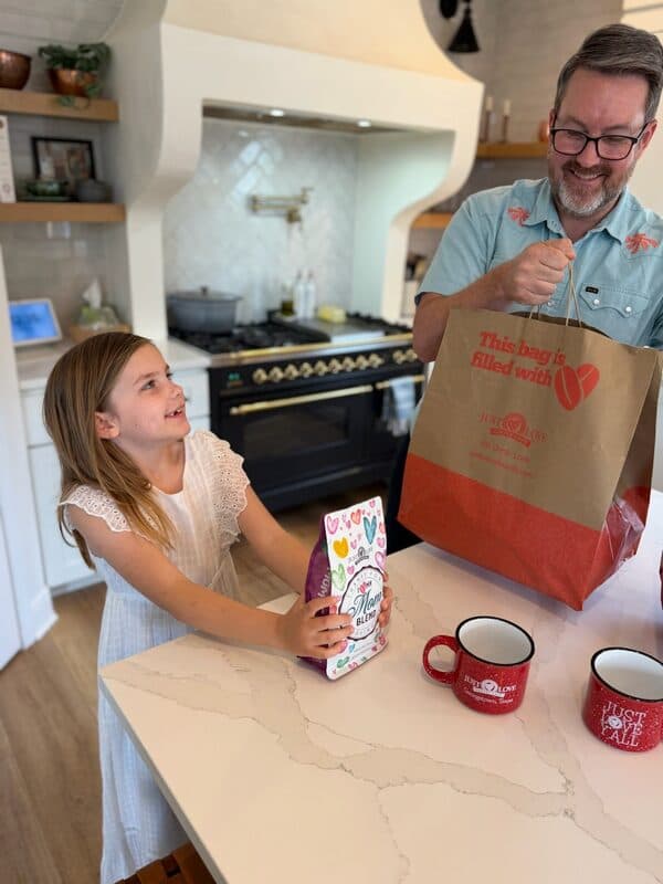A dad and daughter unboxing the Mother's Day Brunch Kit at the kitchen counter