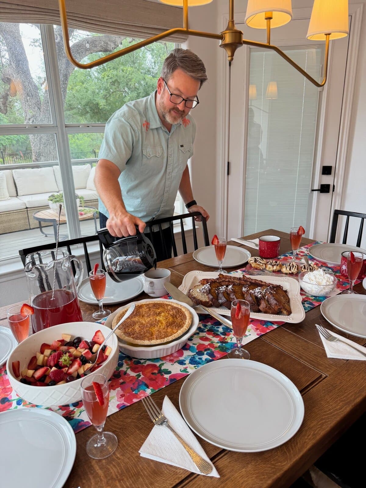 Dad pouring fresh coffee at a set Mother's Day brunch table