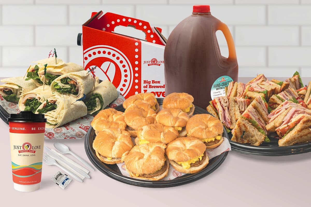 Just Love catering spread: wrap platters, breakfast sandwiches, and house-roasted coffee packed for delivery